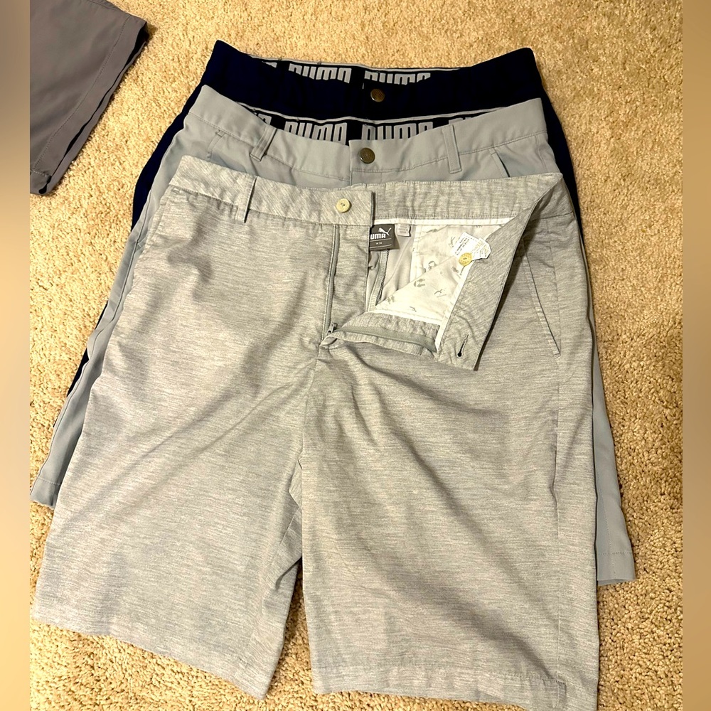 3 pairs of Puma Golf Shorts all size 34 in Heather gray, gray, and navy blue.